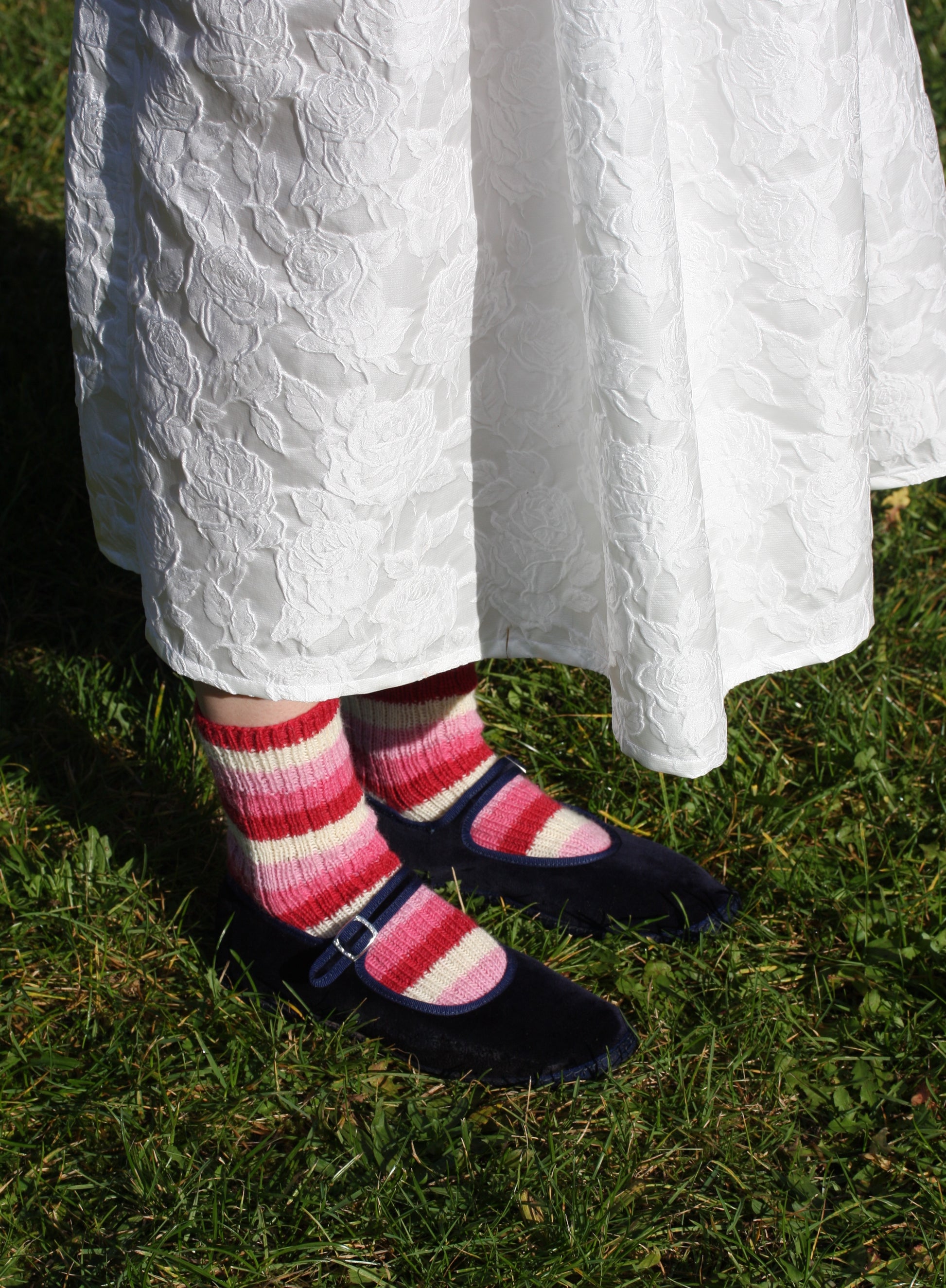 Hand knit wool socks in pink and red stripe