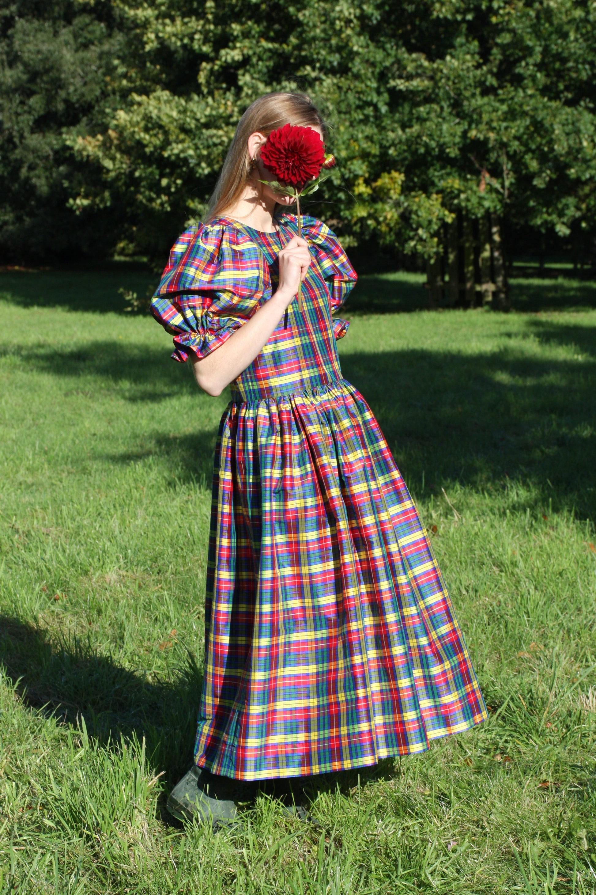 Full length image of long midi length silk dress in red, green and yellow check gingham silk. Designer custom made silk dress