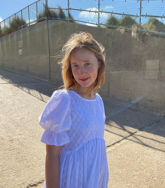 Stunning broderie anglaise dress. Puff sleeves and a curved empire seam and tiered skirt make for a perfect summer dress in white