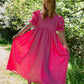 Full length image of perfect wedding guest dress in bright hot pink