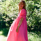 Midi length bright pink dress with puff sleeves, beautiful as a bridesmaid dress