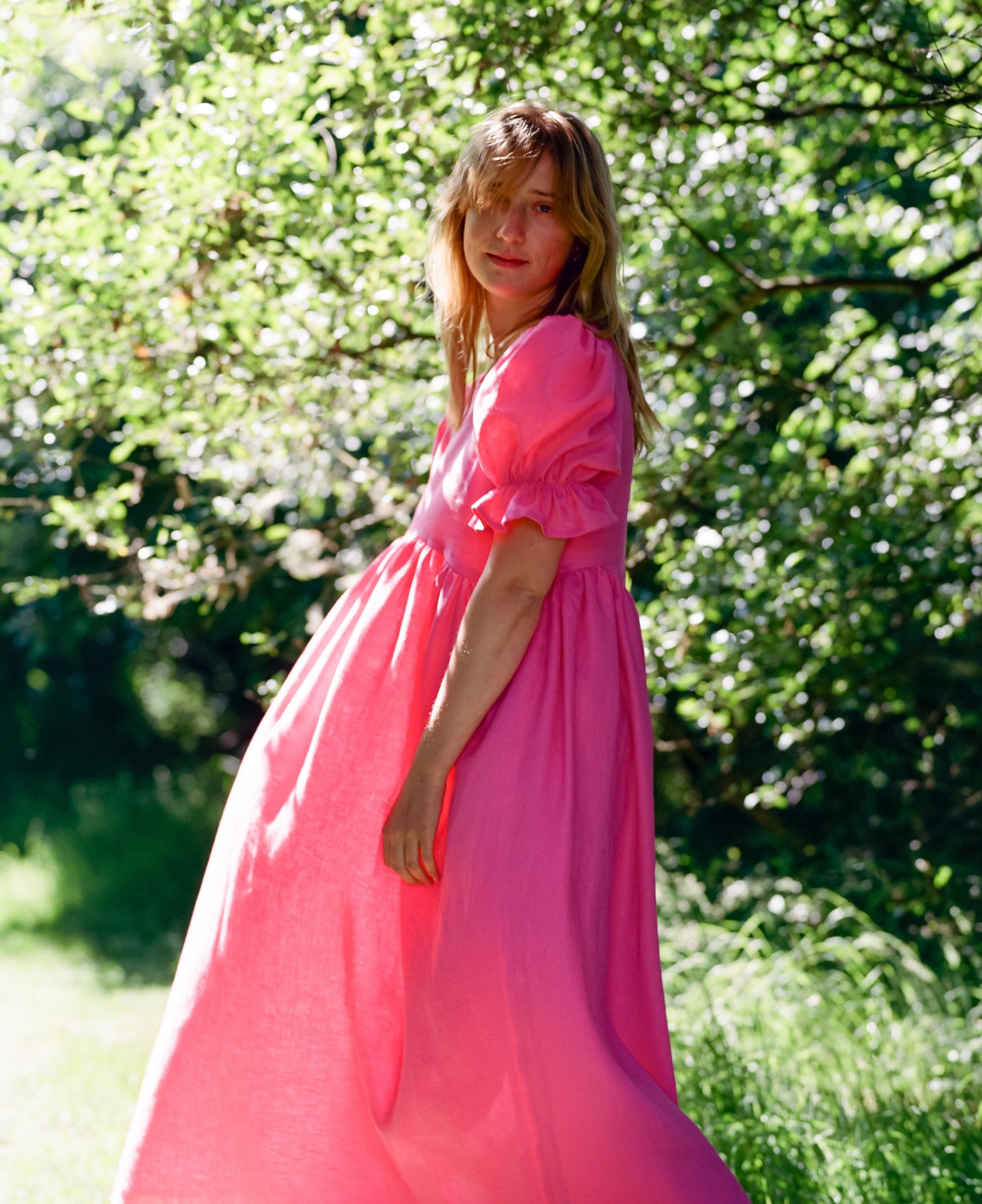 Midi length bright pink dress with puff sleeves, beautiful as a bridesmaid dress
