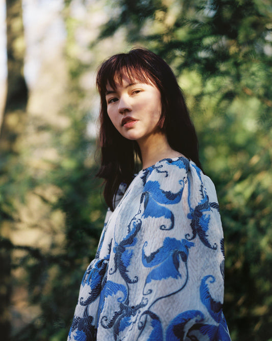 Close up of puff sleeve long sleeve blue dress, made with a beautiful ex designer blue and black embroidered cloqué organza